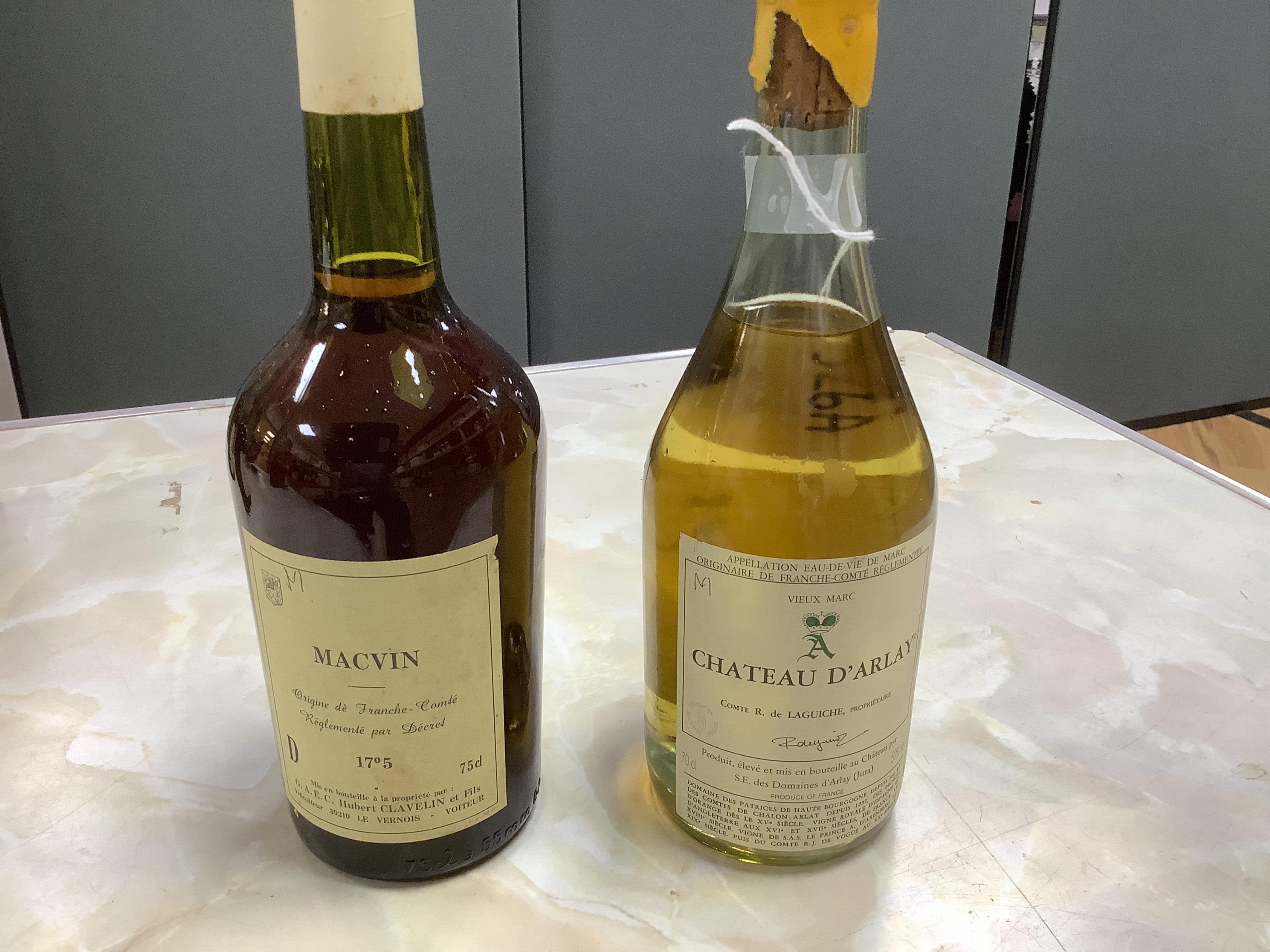 A bottle of Chateau D,Arlay Comte R. de Laguiche and a bottle of Macvin.